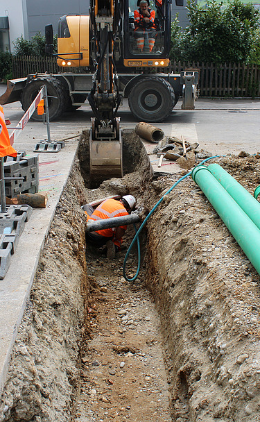 Foto von Arbeiten eines STRABAG Mitarbeitenden im Graben für Werkleitungen in Wangen mit