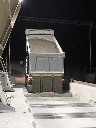Lastwagen kippt obererdig Kies in die Fraktionen.