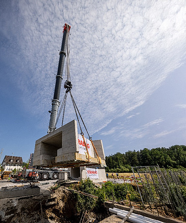 Bauarbeiten in Horgen am Durchlassbauwerk - STRABAG Tiefbau Foto von Arbeiten mit Kran und einem daran hängendem Durchlasswerk