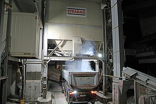 Lastwagen unten, oben Staub, der vom heissen Asphalt kommt
