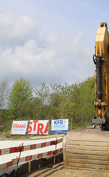 Bauarbeiten in Egerkingen - STRABAG Verkehrswegebau Foto von gelben Bagger bei einer Baustelle von STRABAG