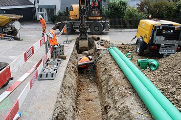 Bauarbeiten in Wangen b. Olten - STRABAG Tiefbau und Strassenbau Mittelland Foto von Arbeiten eines STRABAG Mitarbeitenden im Graben für Werkleitungen in Wangen mit
