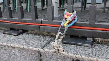 Ansicht von einen Knoten an einem Anschlagpunkt am Metallgeländer vom Holzsteg.