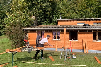 Lernendenlager Pfadiheim Patria Hüttikerberg - STRABAG Holzbau STRABAG Lernender beim zusägen der Latten für die neue Holzfassadenverkleidung des Pfadiheims Hüttikerberg
